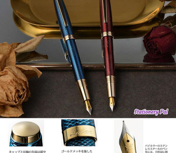 Close-up of Laban GLORIA pens with brass body, guilloché engraving, and gold accents. Luxury writing instruments from Taiwan designed for collectors and stationery lovers.