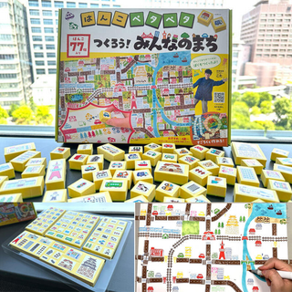 A colorful Japanese stamp kit called “Hanko Petapeta, Let’s Build Our Town,” featuring 77 stamps, play sheets, and stickers for kids and adults to create their own mini town maps.